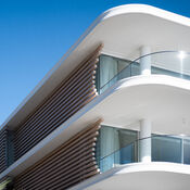 Looking up at the curved lines of a building façade at Bower.