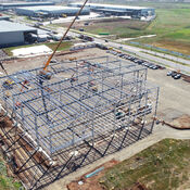 An aerial view of the Calendar Cheese factory construction site, with the building frame being completed.